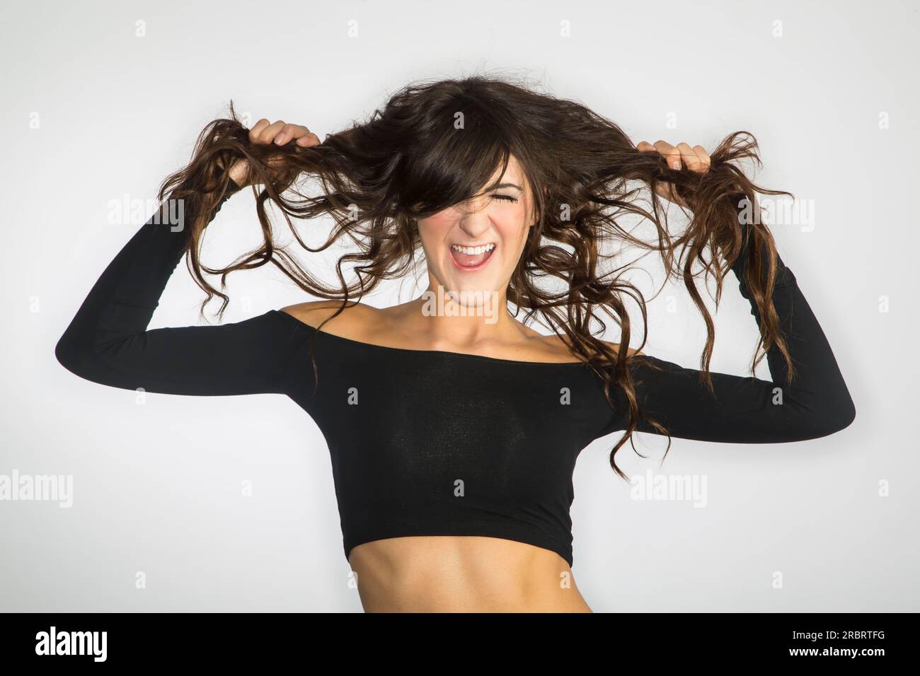 A dark haired model screaming, showing emotion Stock Photo