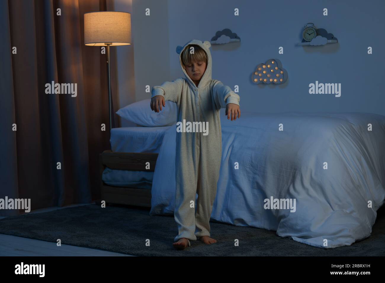 Boy in pajamas sleepwalking indoors at night Stock Photo Alamy