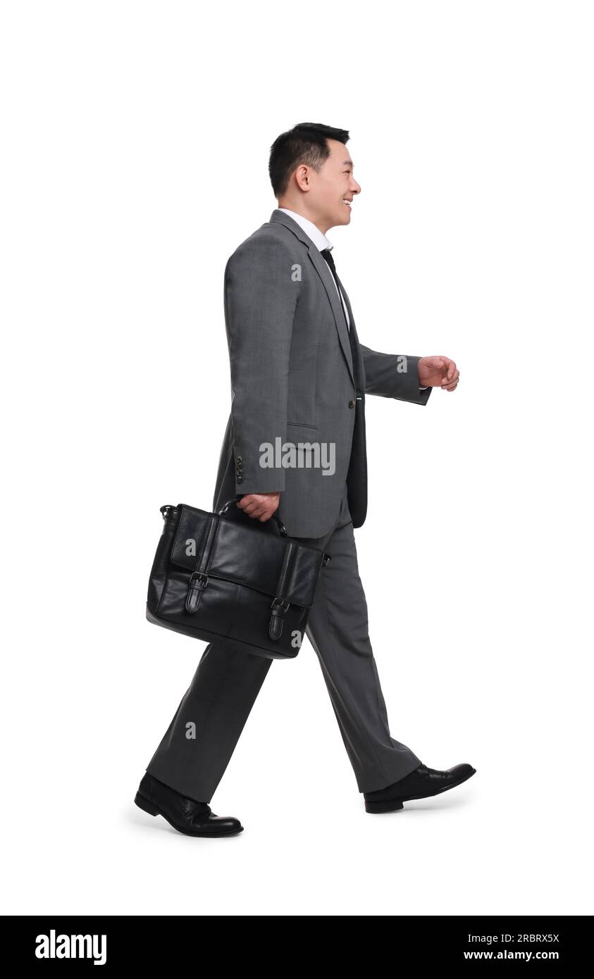 Businessman with briefcase walking on white background Stock Photo - Alamy