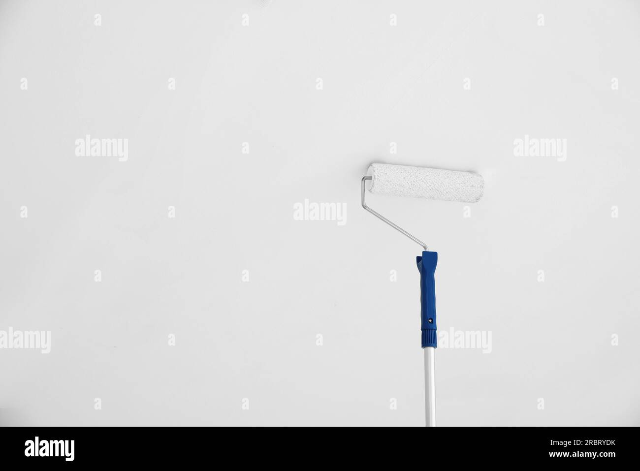 Painting ceiling with white dye indoors, bottom view. Space for text Stock Photo Alamy