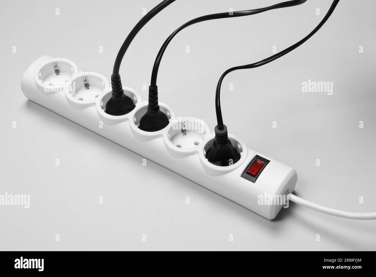 Power strip with electrical plugs on white background Stock Photo Alamy