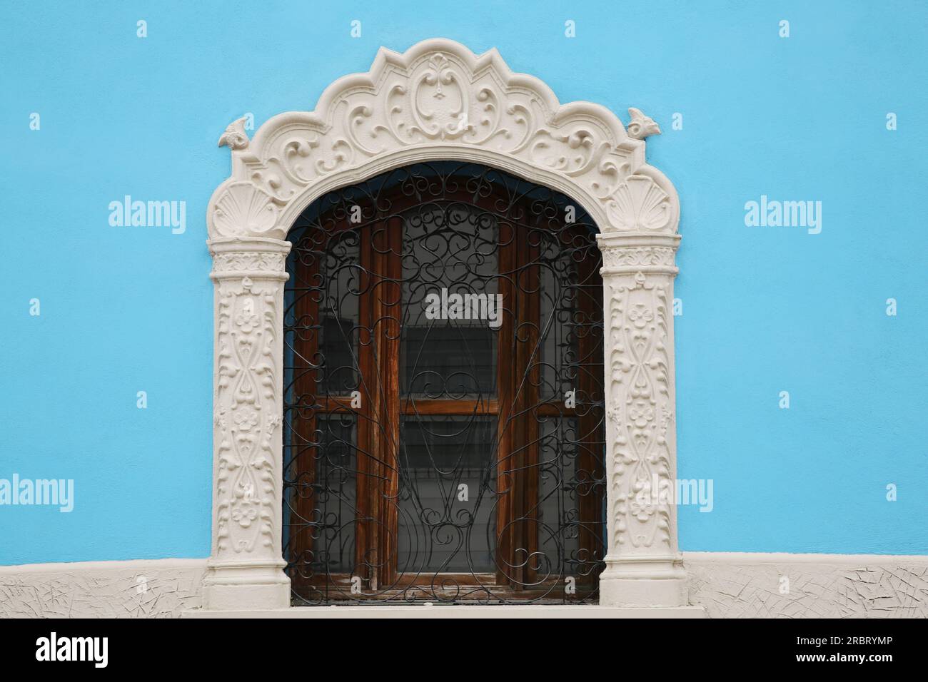 Light blue building with beautiful window and steel grilles Stock Photo ...