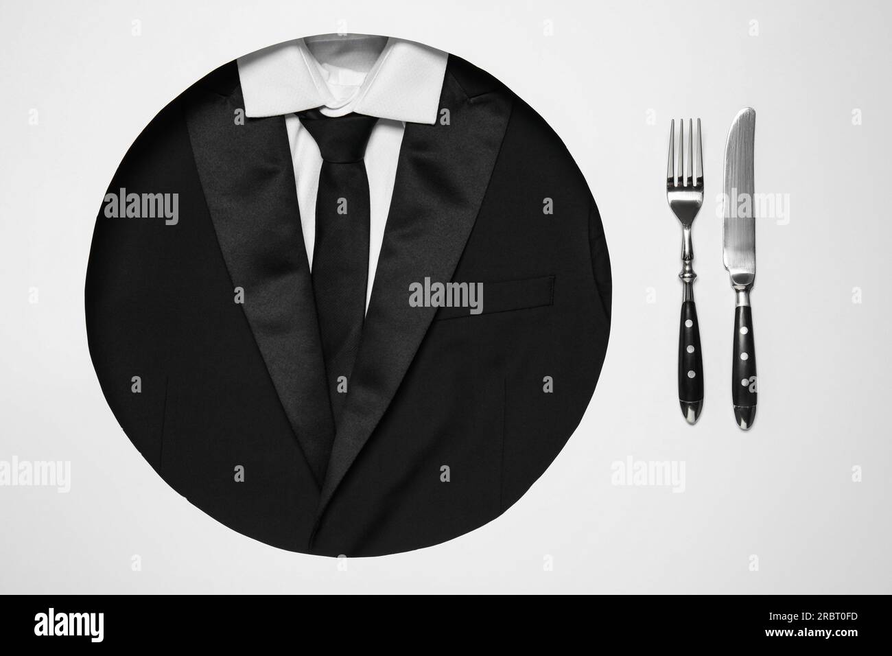 Creative business lunch layout. Hole with suit as plate and cutlery on