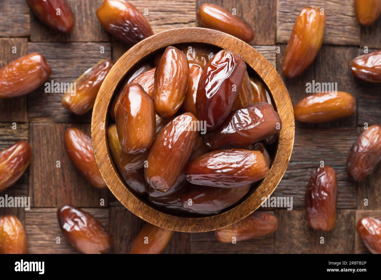 dried date fruit in bowl on wooden table background. Stock Photo