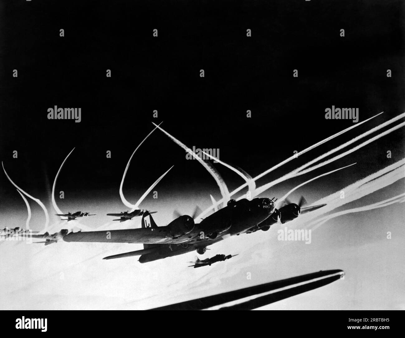 Europe,  January 20, 1944 B-17 Flying Fortresses of the US Army 8th Air Force and accompanying fighter planes leave vapor trails in the sky as they head on another bombing raid of Hitler's 'Fortress Europa'. Stock Photo