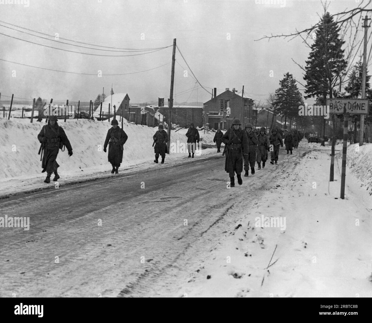Bastogne, Belgium, December 29, 1944 Members of the 101st Airborne Division move out Bastogne to drive the Germans besieged them for ten days out of a neighboring town. American and German forces at the Belgian town of Bastogne, as part of the larger Battle of the Bulge. Stock Photo