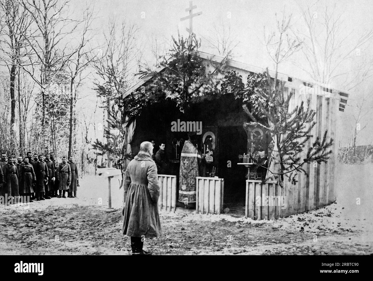 France:  February 19, 1917 General Lohvitsky and Russian soldiers stand bareheaded before a makeshift Russian church on the French Front where a Russian priest is celebrating religious services. Lohvitsky is the commander of all Russian forces in France. Stock Photo