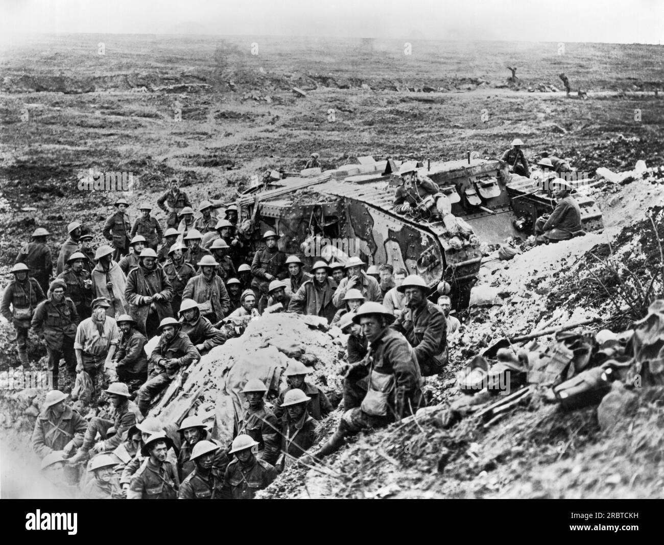 Flers, France: September 24, 1916 British troops and a Mark I tank two days after the fall of Flers. The Battle of Flers–Courcelette during the Somme Offensive was the first time tanks were used in warfare. Stock Photo