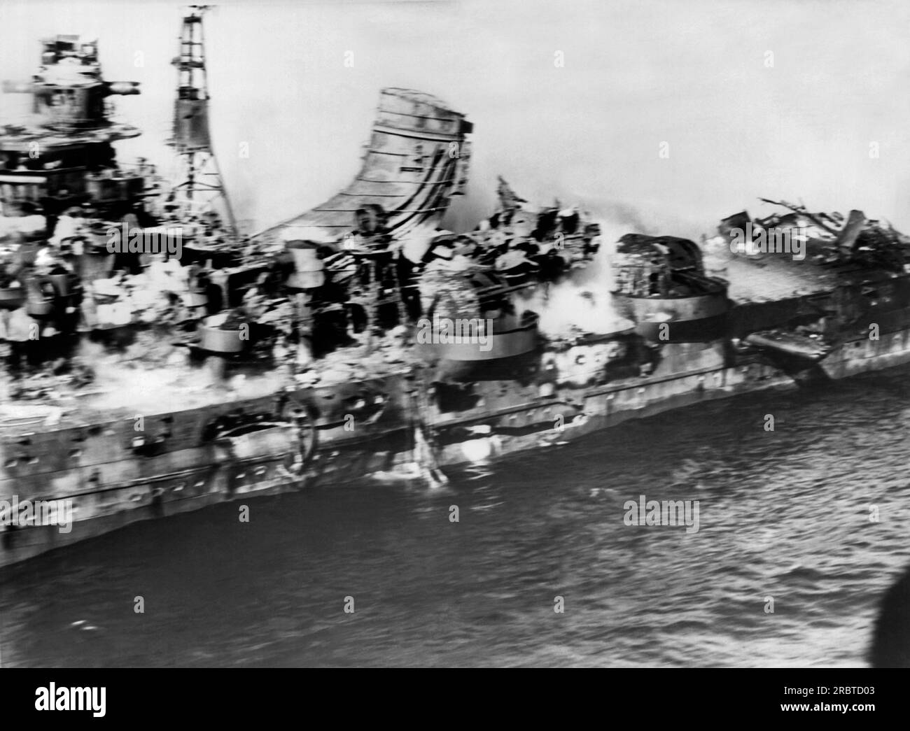 Midway Atoll, June, 1942 A US Navy plane flies close by viewing the damage done to a Japanese