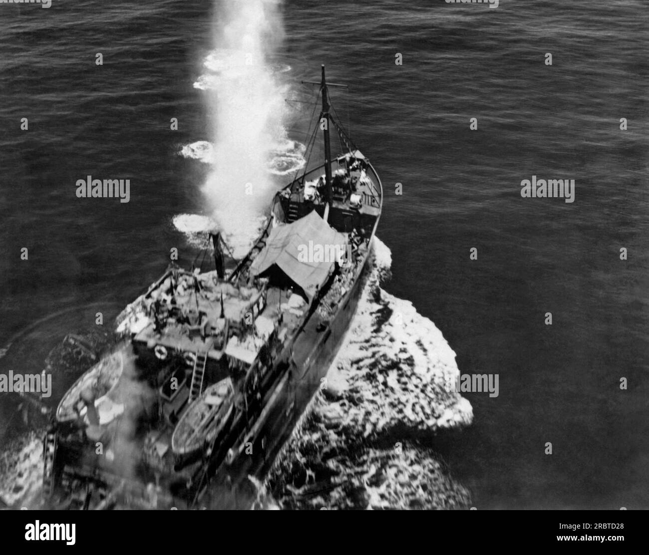 Pacific Ocean,  November 10, 1943 A Japanese freighter in the southwest Pacific being attacked and eventually sunk by a US Army bomber. Stock Photo