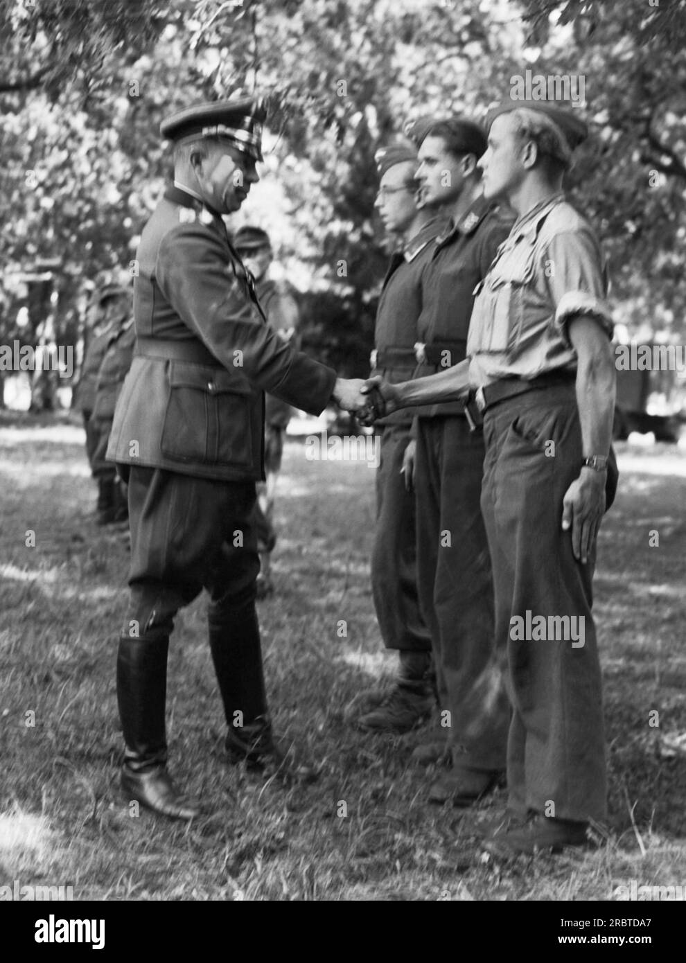 Loire River, France:  September 18, 1944 German Major General Erich Elster shakes hands with a cross section of his 19,000 men that he surrendered to the Americans. Stock Photo