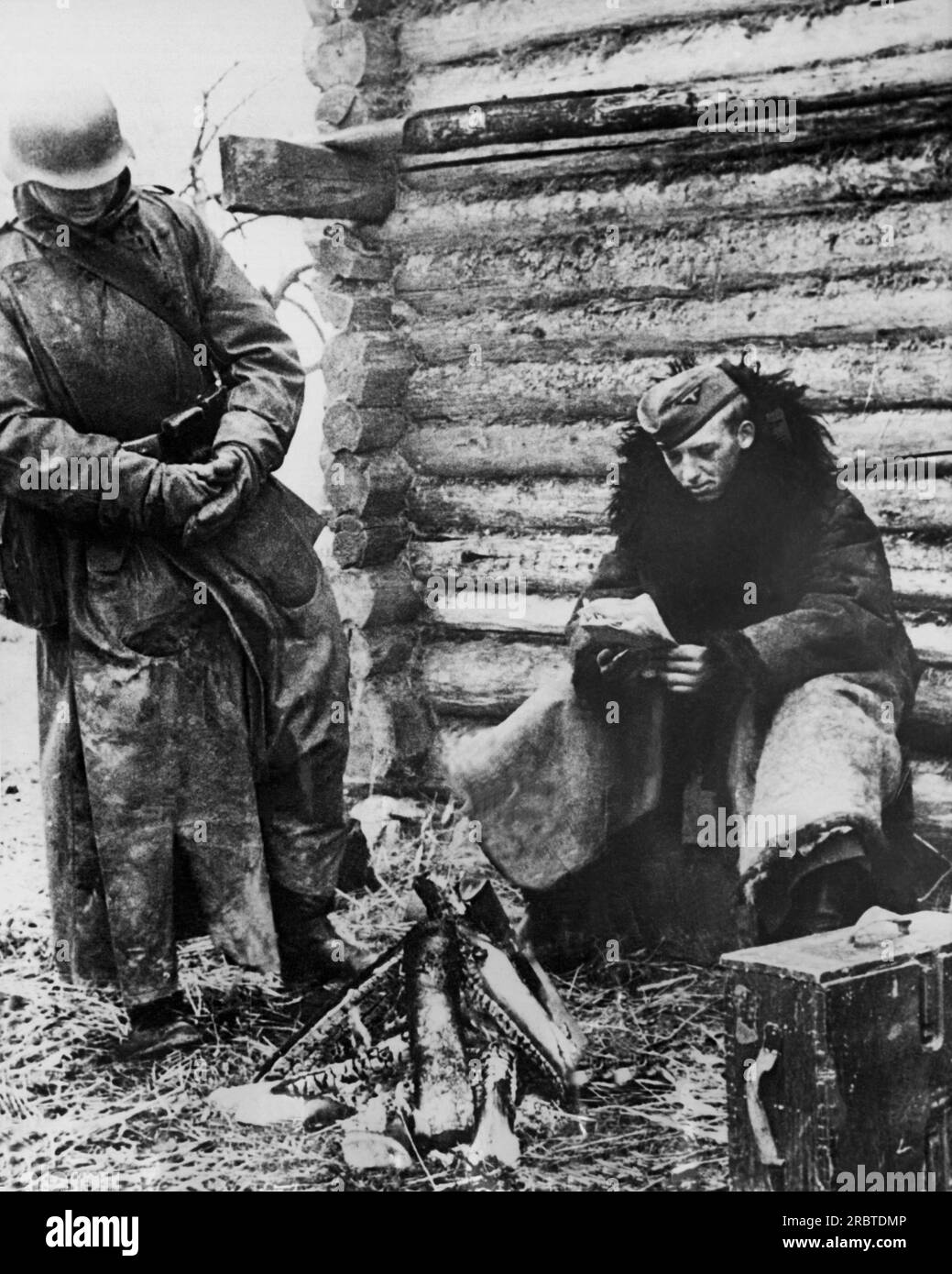 Russia:  September, 1941 German soldiers stand by a wood fire to warm up during a halt in operations on the Russian front. Stock Photo