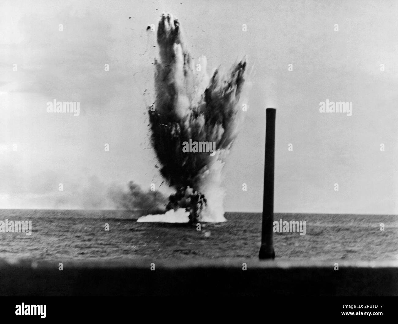 Pacific Ocean,  May 28, 1943 A Japanese trawler refused to sink from shell fire from a US Navy sub's deck gun, and instead fired back, killing an officer, so then the submarine fired a torpedo. Stock Photo