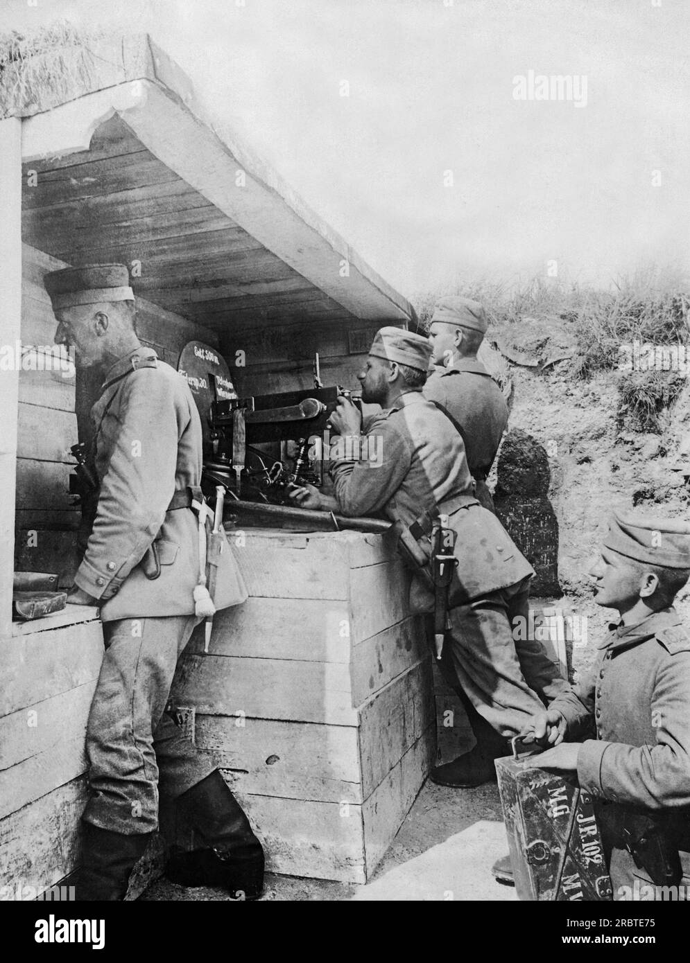 Europe: July 15, 1916 A German machine gun crew firing upon the enemy 200 meters away.The crew is under a bomb proof shelter and is firing 600 bullets a minute. Stock Photo