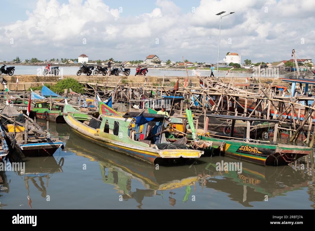 Rows of fishing net boats parked at a fish auction in Indonesia Stock Photo