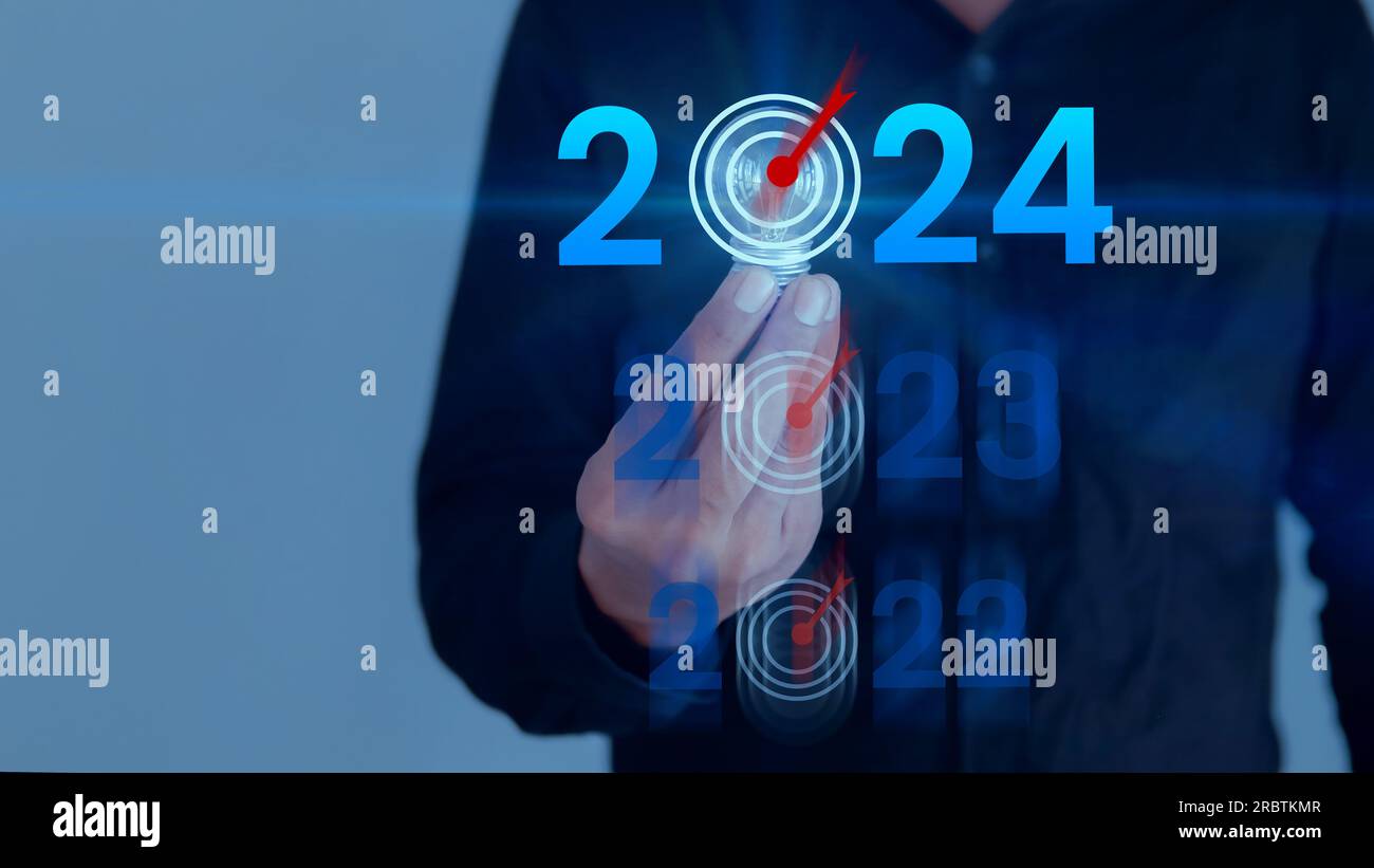 Businessman holding light bulb with target 2022 to 2024 for