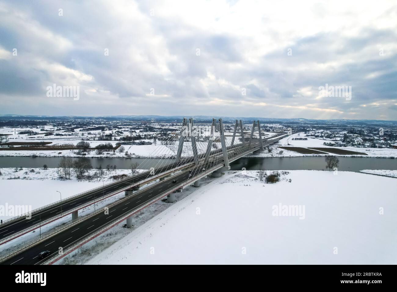 Macharski Bridge over the river Vistula winter time, snowy day, expressway S7, Nowa Huta, Krakow, Poland, aerial view, by drone Stock Photo