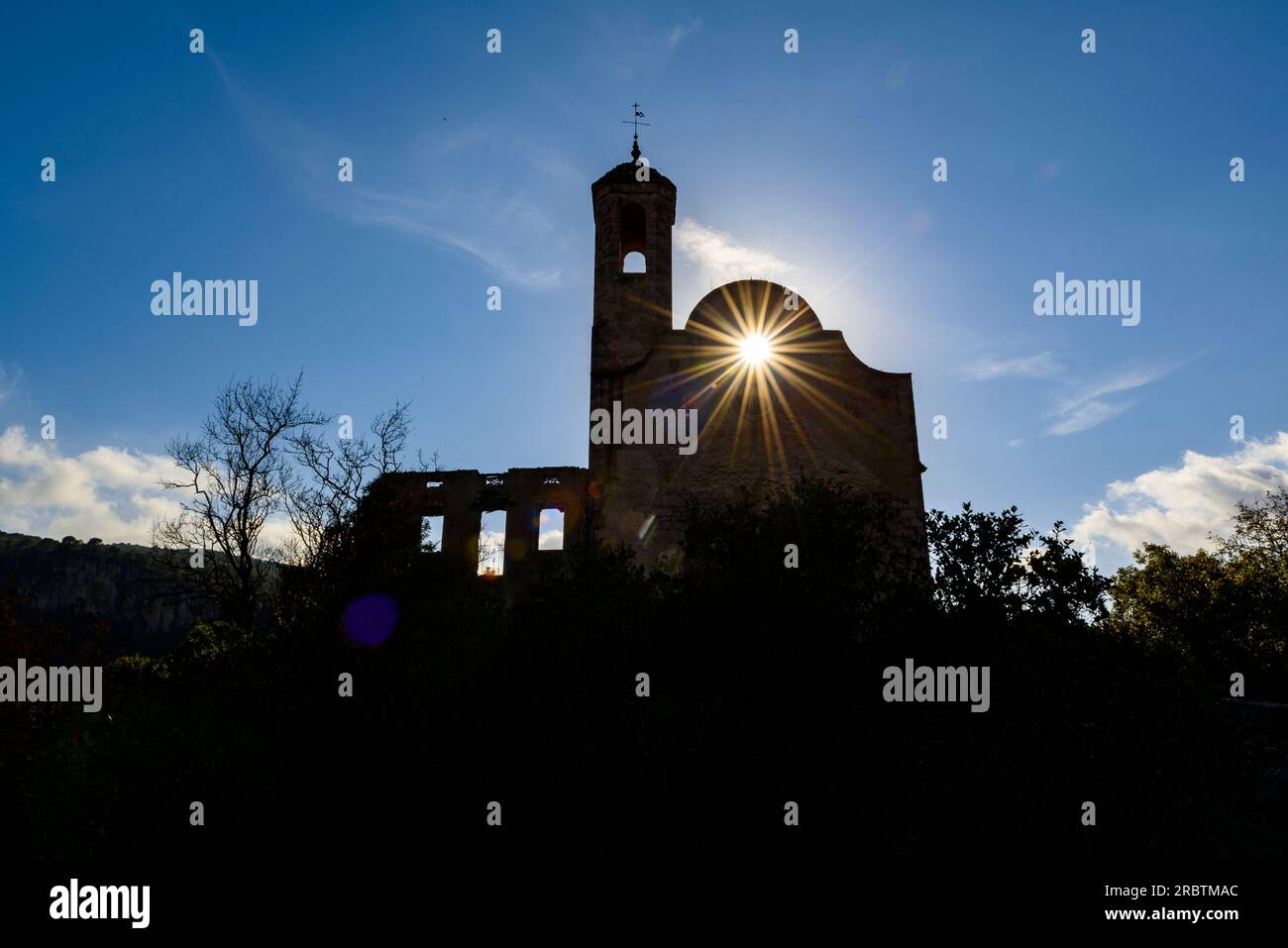 The abandoned church of Santa Perpètua de Gaià in a backlight with the sun (Alt Camp, Tarragona, Catalonia, Spain) Stock Photo