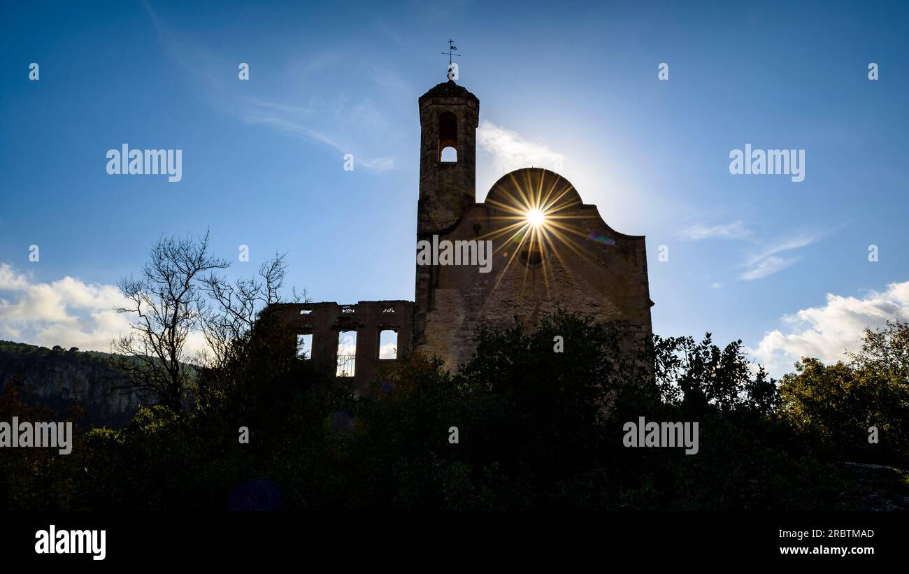 The abandoned church of Santa Perpètua de Gaià in a backlight with the sun (Alt Camp, Tarragona, Catalonia, Spain) Stock Photo