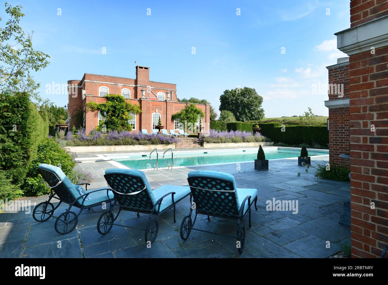 Luxury sun beds by a pool. Stock Photo