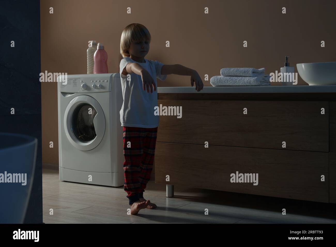 Boy in pajamas sleepwalking indoors at night Stock Photo Alamy