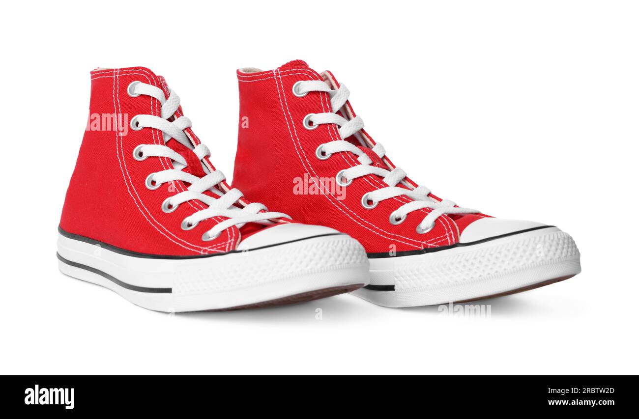 Pair of new red stylish high top plimsolls on white background Stock Photo