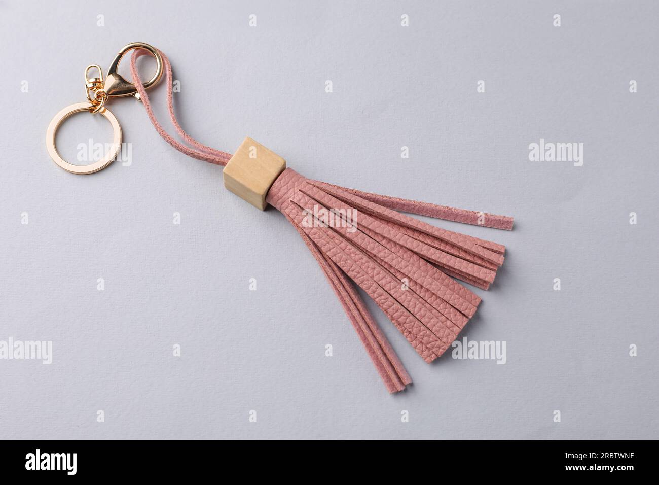 Pink leather keychain on light grey background, above view Stock Photo