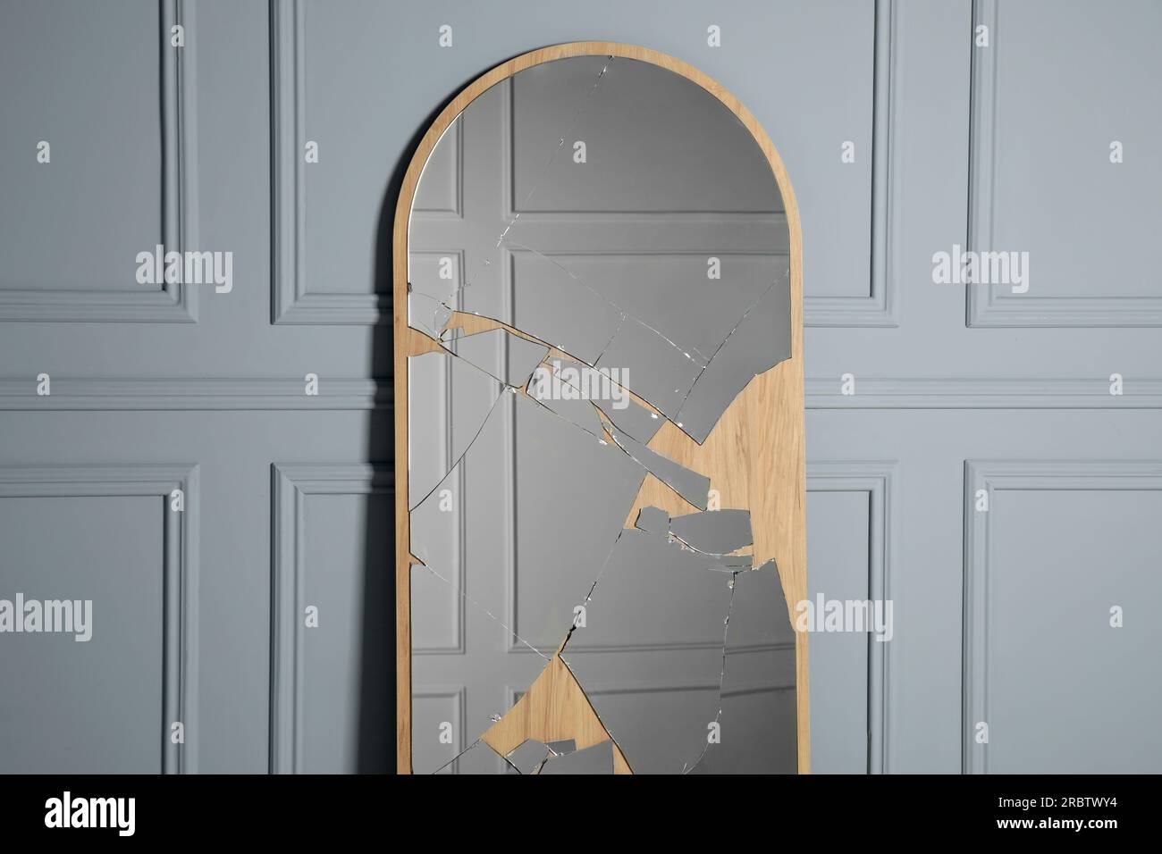 Broken mirror with many cracks near grey wall Stock Photo Alamy