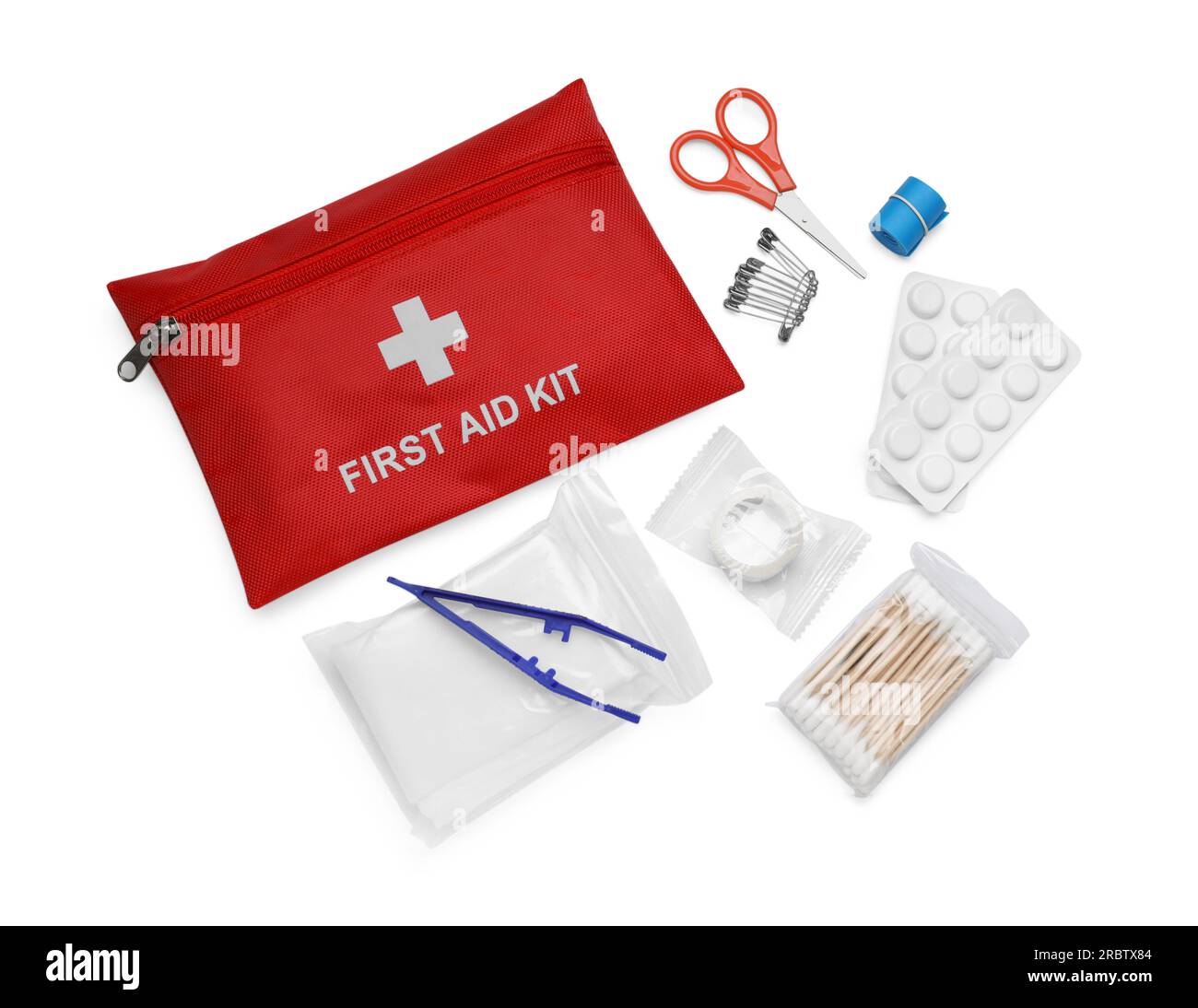 Red first aid kit, scissors, pins, cotton buds, pills, plastic forceps