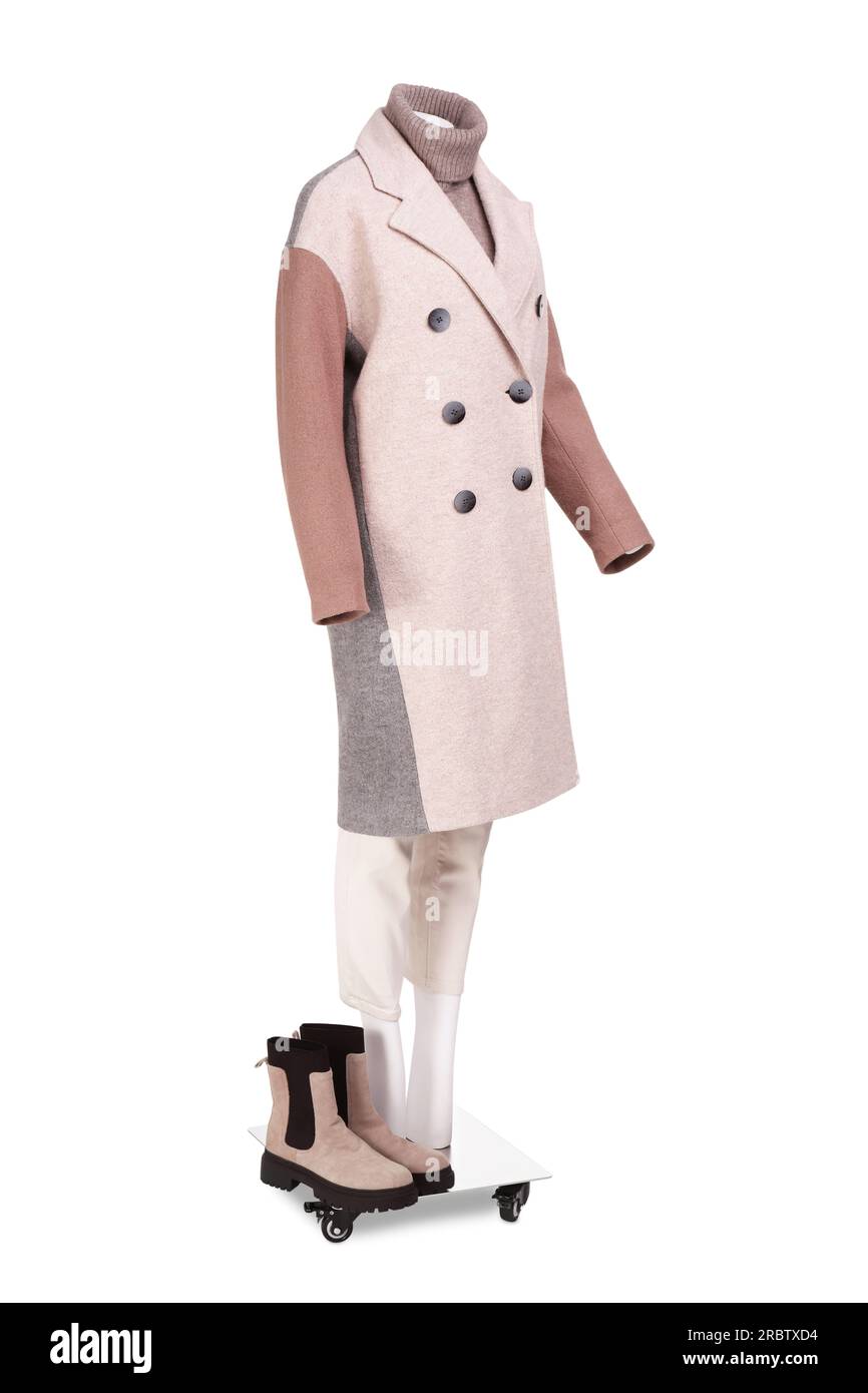Female mannequin with boots dressed in stylish coat, sweater and pants
