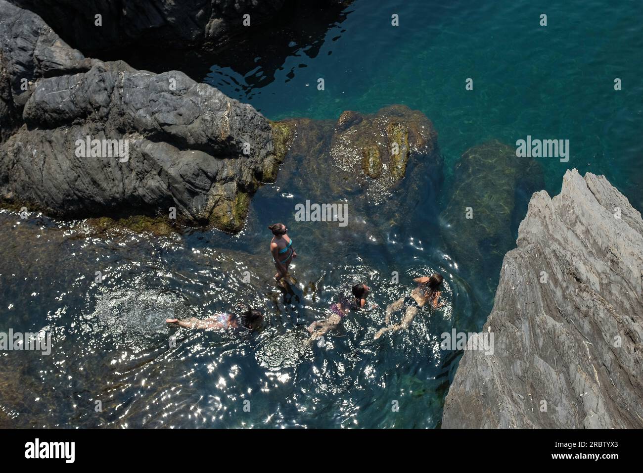 Cinque Terre, Italy aerial view of women in bikinis swimming on the