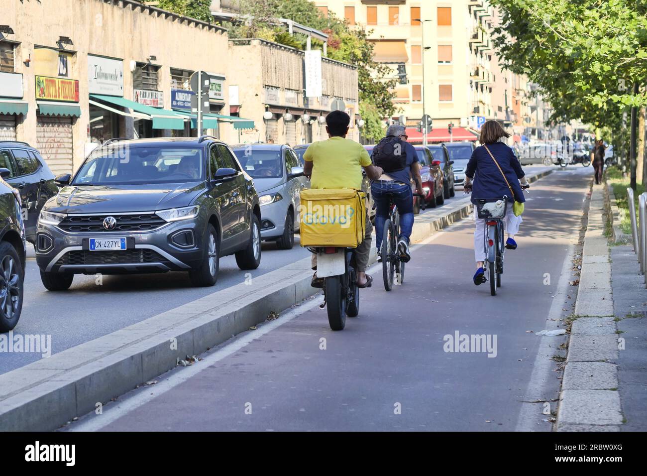Bicycle food delivery rider working in the street of Milan before ...
