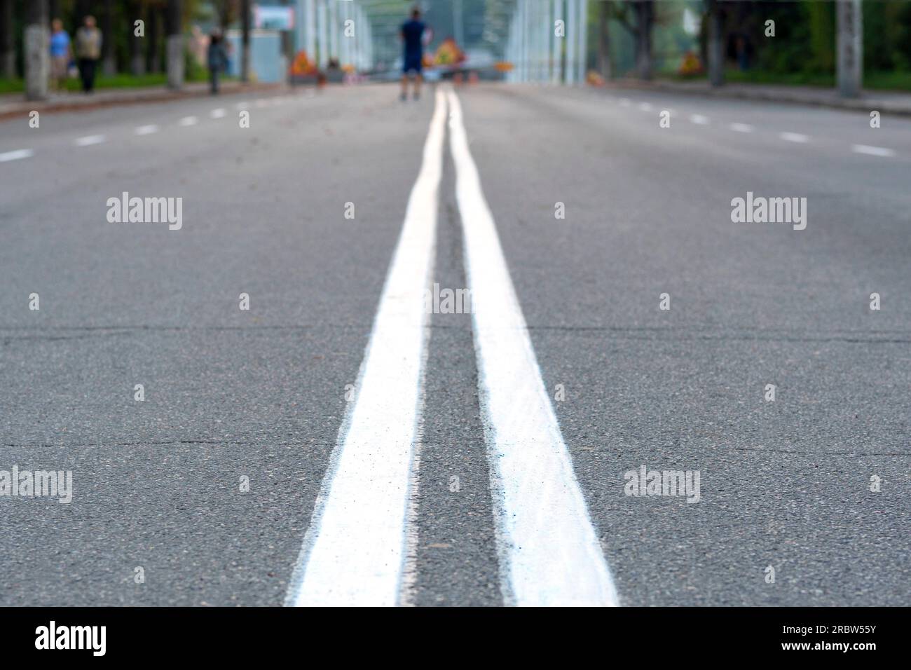 The asphalted road with two continuous white strips. The highway with a