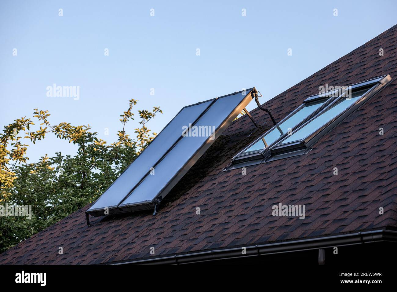 Solar energy. Water solar collector on a roof Stock Photo - Alamy