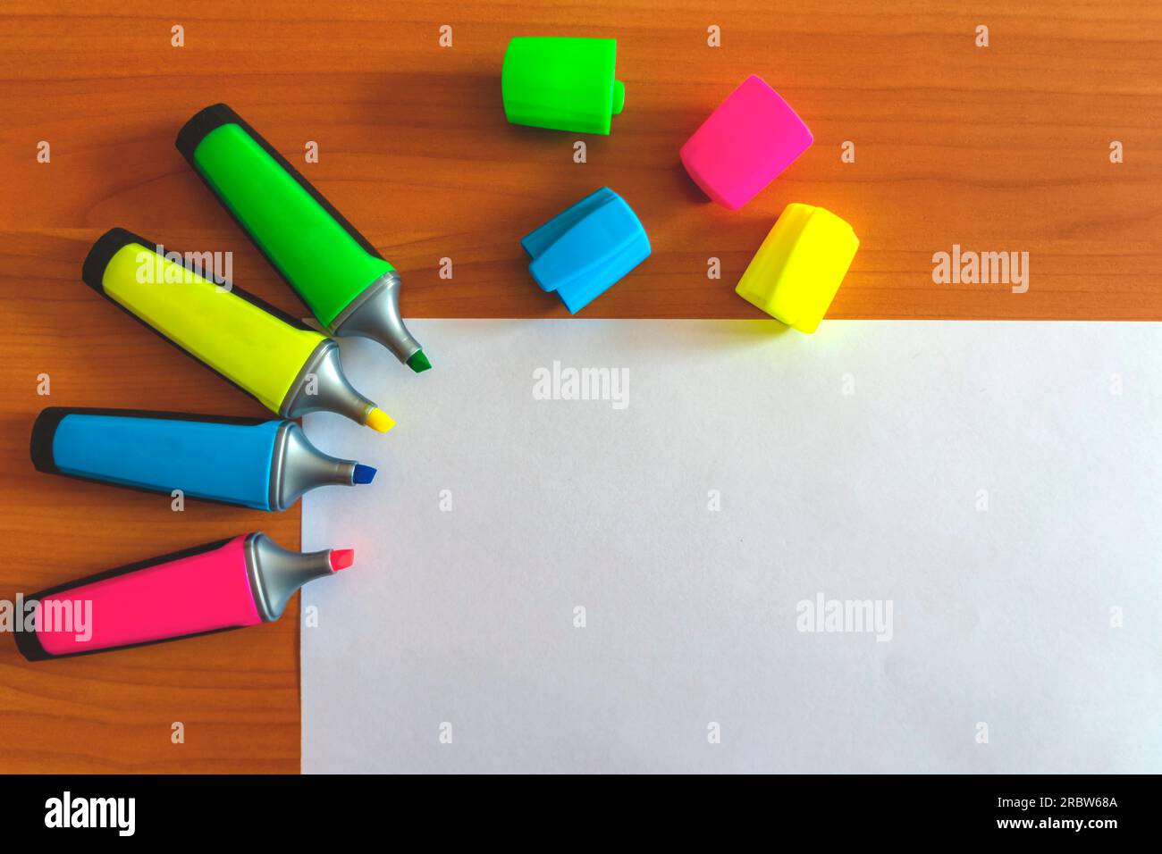 Multicolored markers. White paper and multi-colored caps. Markers pattern. Stock Photo