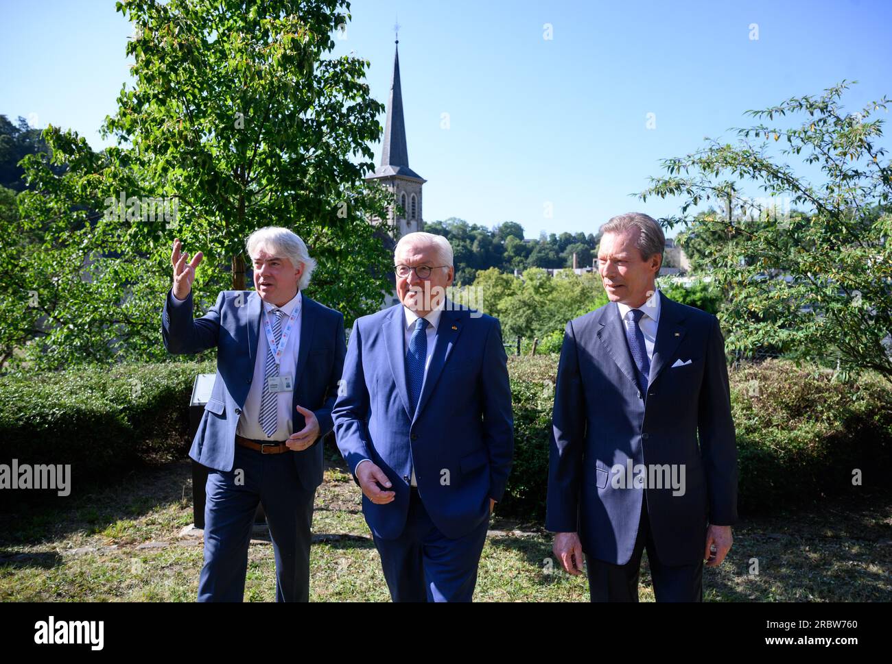 Luxemburg, Luxembourg. 11th July, 2023. German President Frank-Walter Steinmeier (m) and Grand Duke Henri of Luxembourg (r) visit Robert Schuman's birthplace together and are guided through the garden there by Andreas Fickers (l), director of the Luxembourg Center for Contemporary and Digital History. President Steinmeier and his wife are in Luxembourg for a two-day official visit. Schuman was French prime minister. Credit: Bernd von Jutrczenka/dpa/Alamy Live News Stock Photo