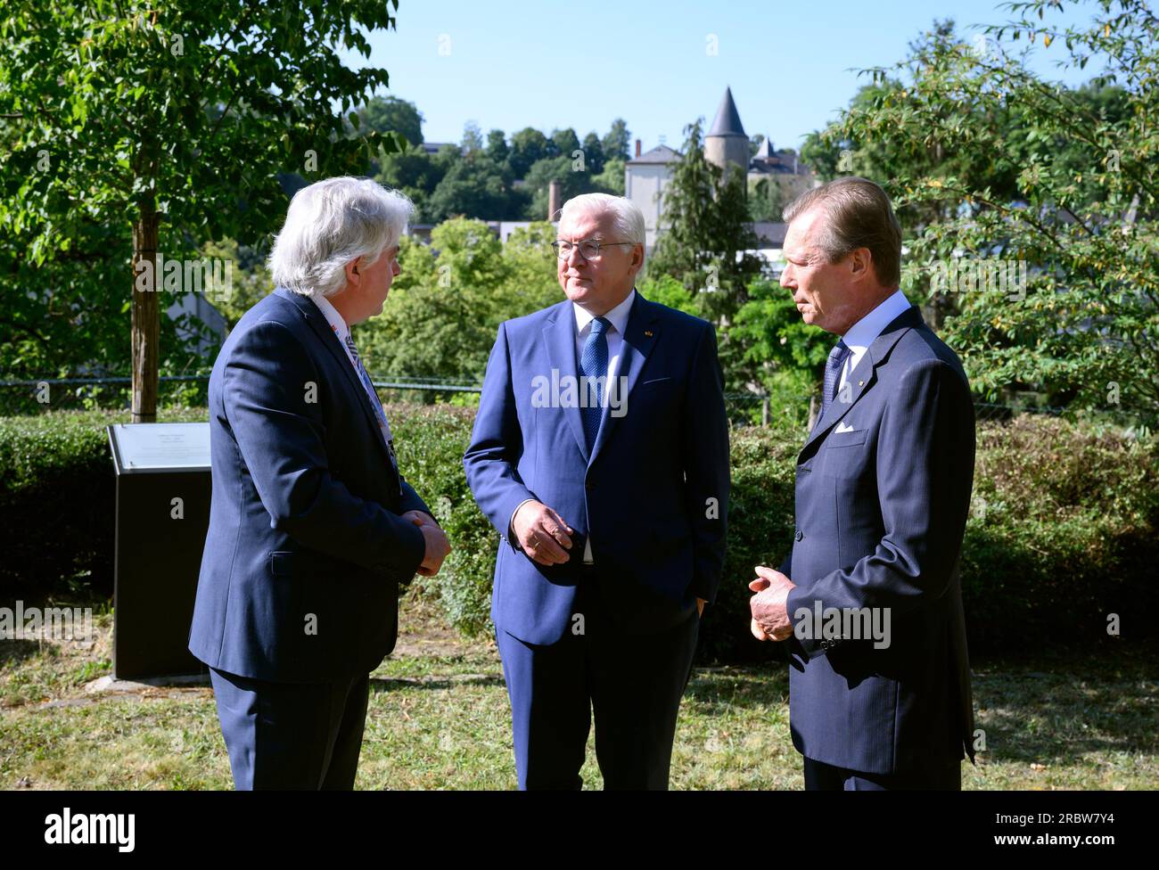 Luxemburg, Luxembourg. 11th July, 2023. German President Frank-Walter Steinmeier (m) and Grand Duke Henri of Luxembourg (r) visit Robert Schuman's birthplace together and are guided through the garden there by Andreas Fickers (l), director of the Luxembourg Center for Contemporary and Digital History. President Steinmeier and his wife are in Luxembourg for a two-day official visit. Schuman was French prime minister. Credit: Bernd von Jutrczenka/dpa/Alamy Live News Stock Photo