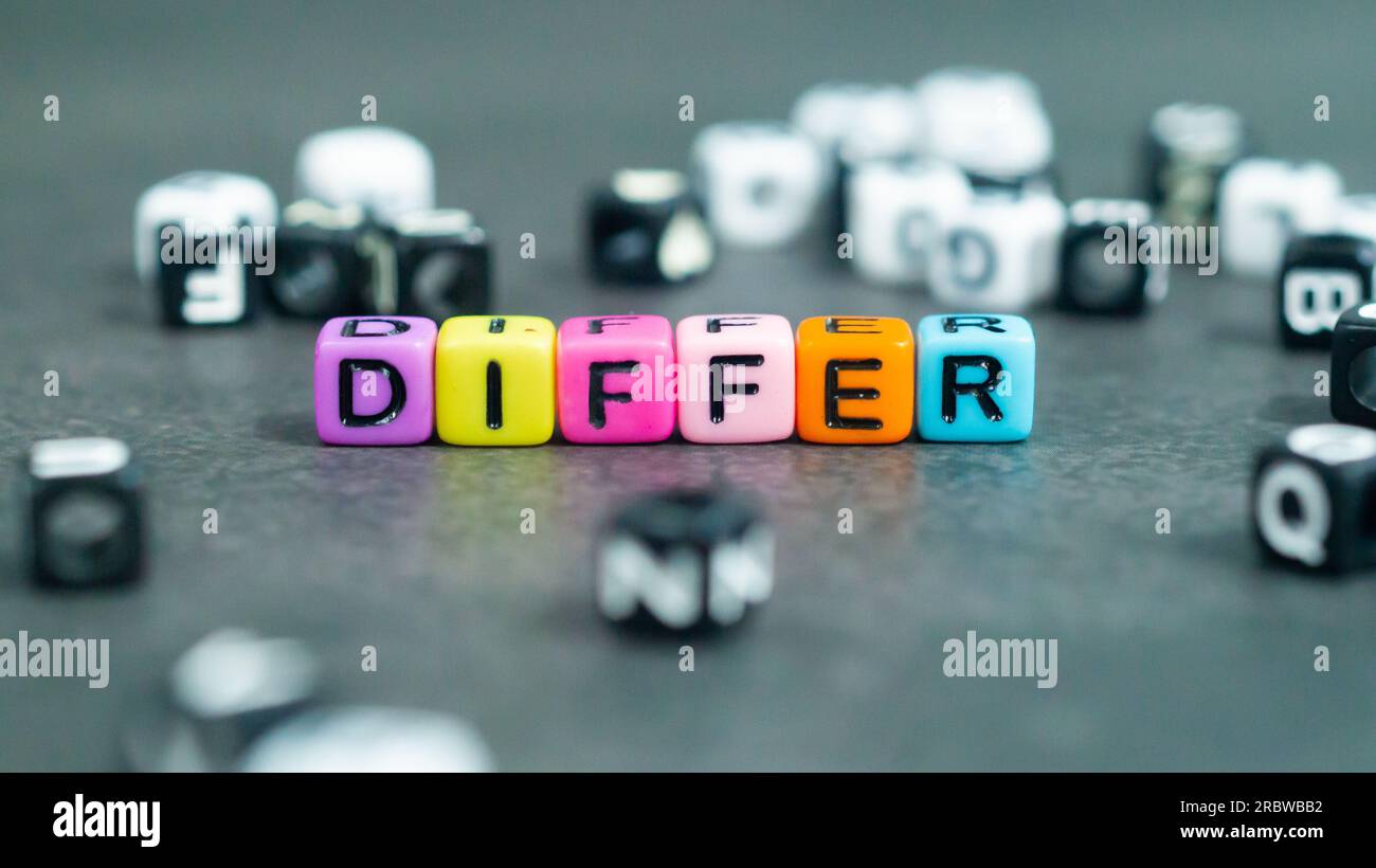 Differ slogan in colorful bead letters. Motivation inspiration self confidence uniqueness concept Stock Photo