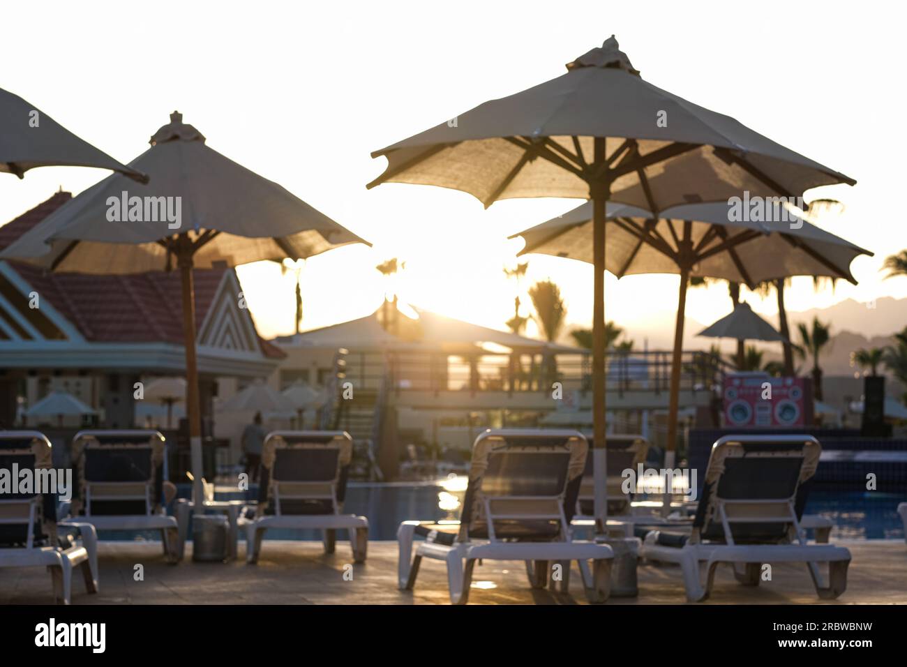 Sunbeds near swimming pool at luxury resort Stock Photo Alamy