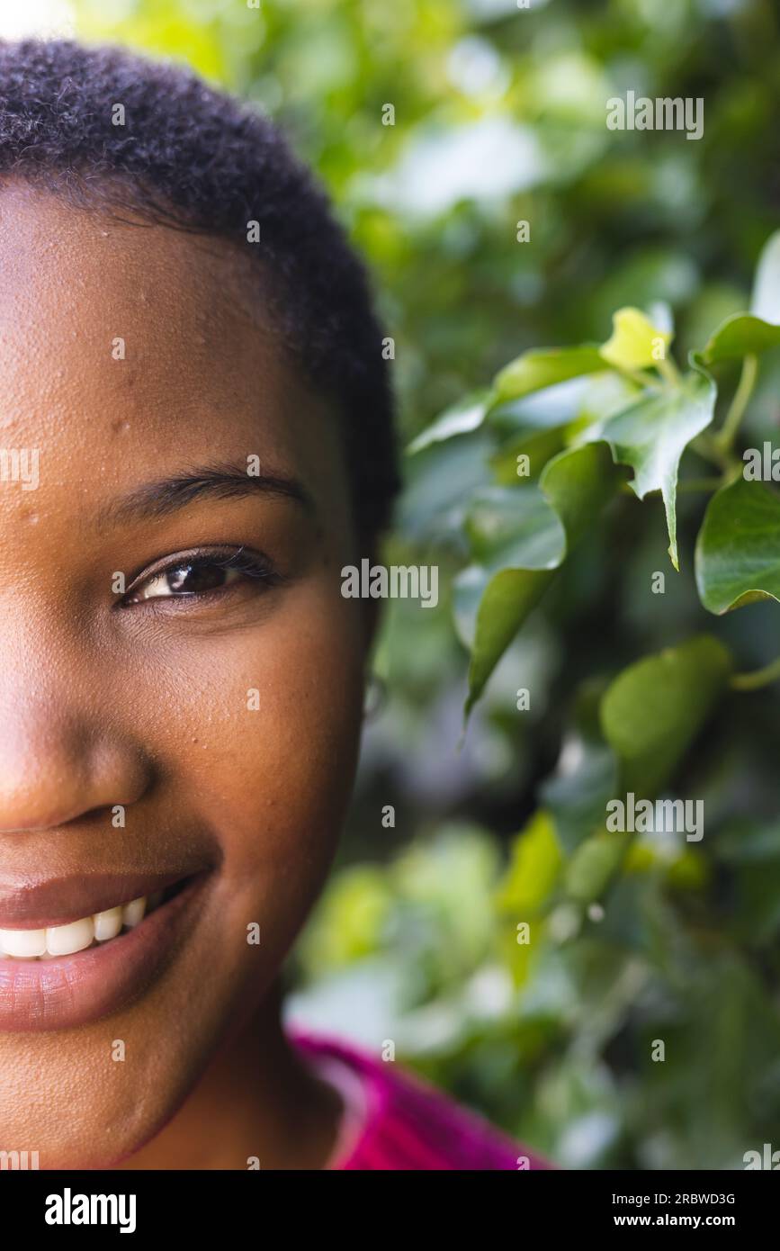 Half portrait of happy african american woman with copy space in sunny ...