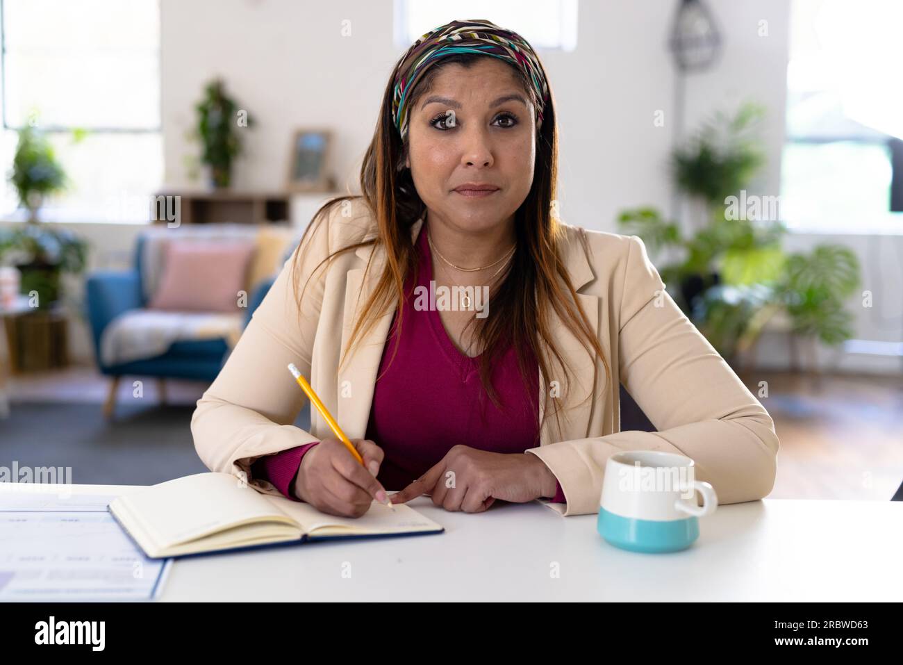 Biracial casual businesswoman making video call in office Stock Photo