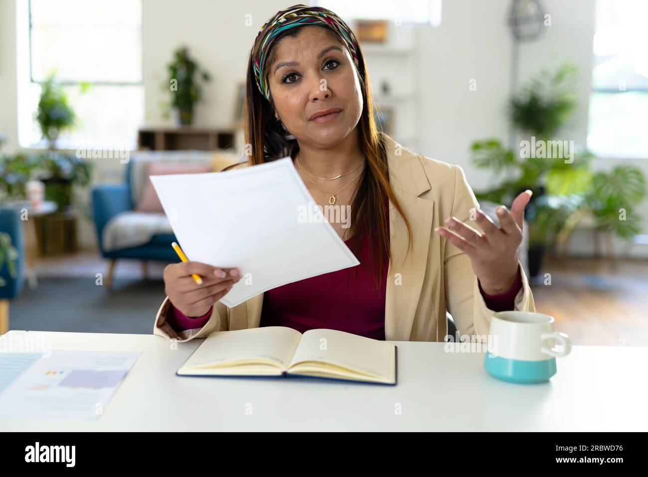 Biracial casual businesswoman making video call in office Stock Photo