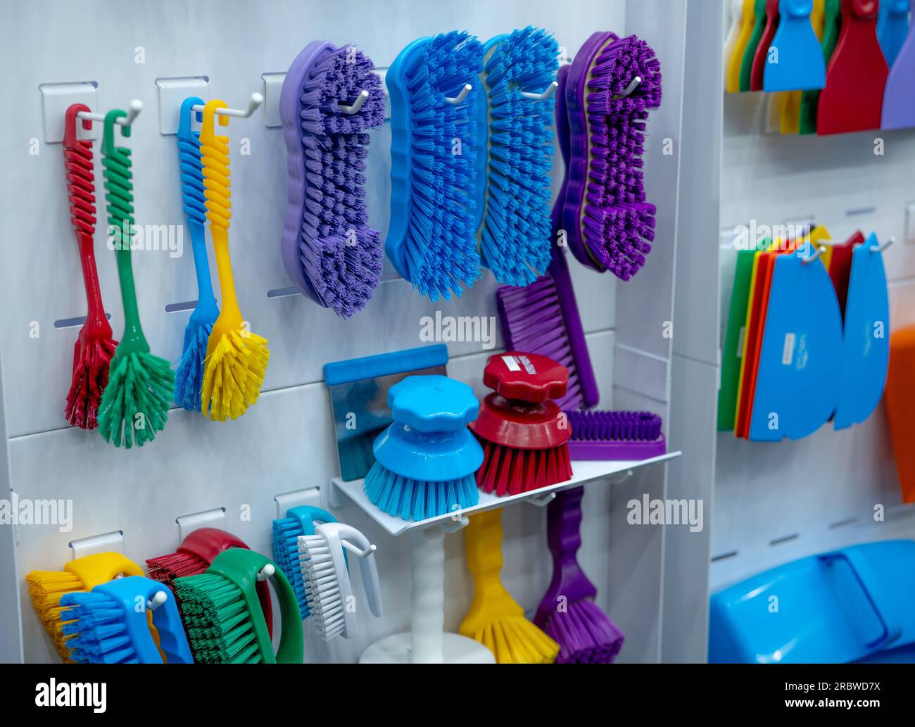 Brushes hang on shelf. Dish wash brush, professional double wing scrub, round scrub for food