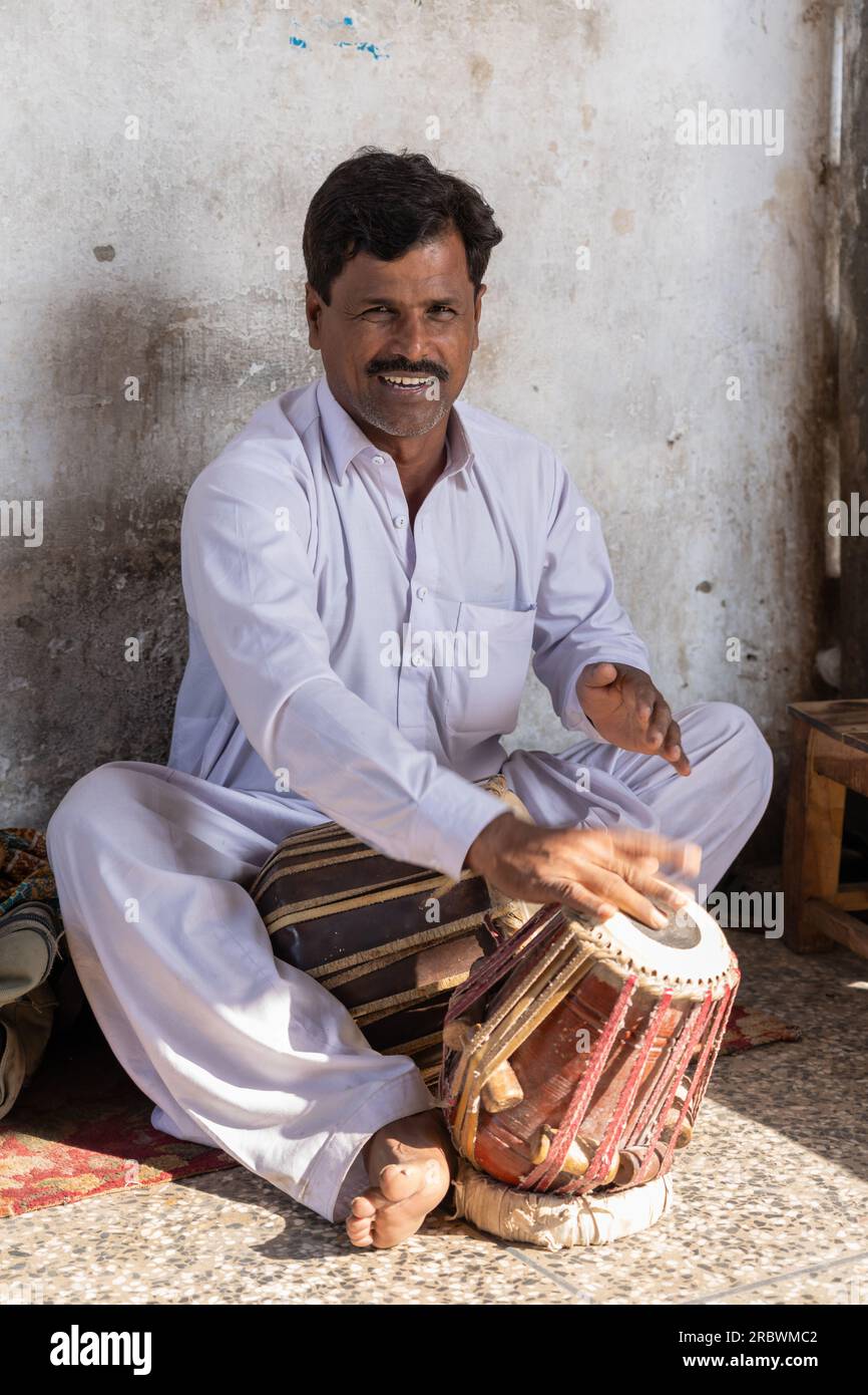 Multan, Punjab, Pakistan - 11 12 2019 : Male musician playing traditional tabla drum in sufi shamsuddin sabzwari mausoleum Stock Photo