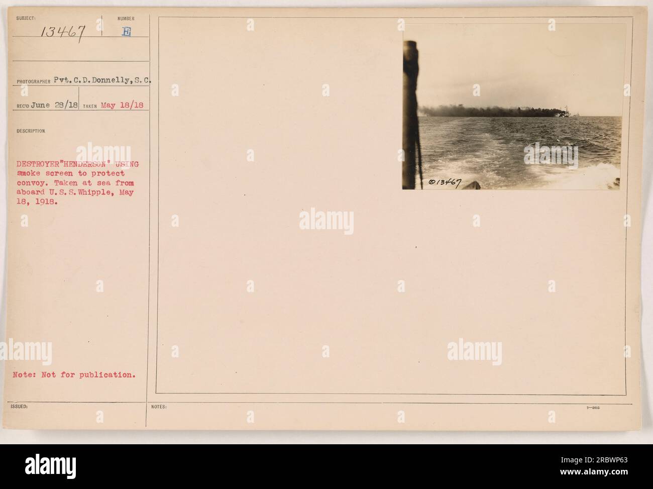 A smoke screen is being used by the destroyer 'Henderson' to protect a convoy at sea. The photo was taken from aboard the U.S.S. Whipple on May 18, 1918. The captioned photo, with subject number 13467, was taken by Pvt. C. D. Donnelly and is part of the Photographs of American Military Activities during World War One collection. Stock Photo