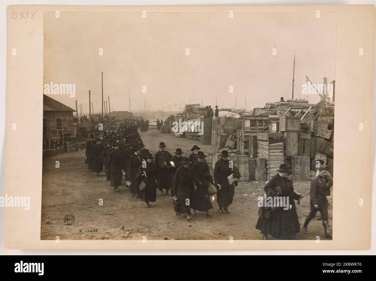 Soldiers unloading supplies from a horse-drawn wagon. The image showcases the logistical efforts of the American military during World War One, highlighting the importance of transportation and supply management in sustaining the troops on the front lines. Stock Photo