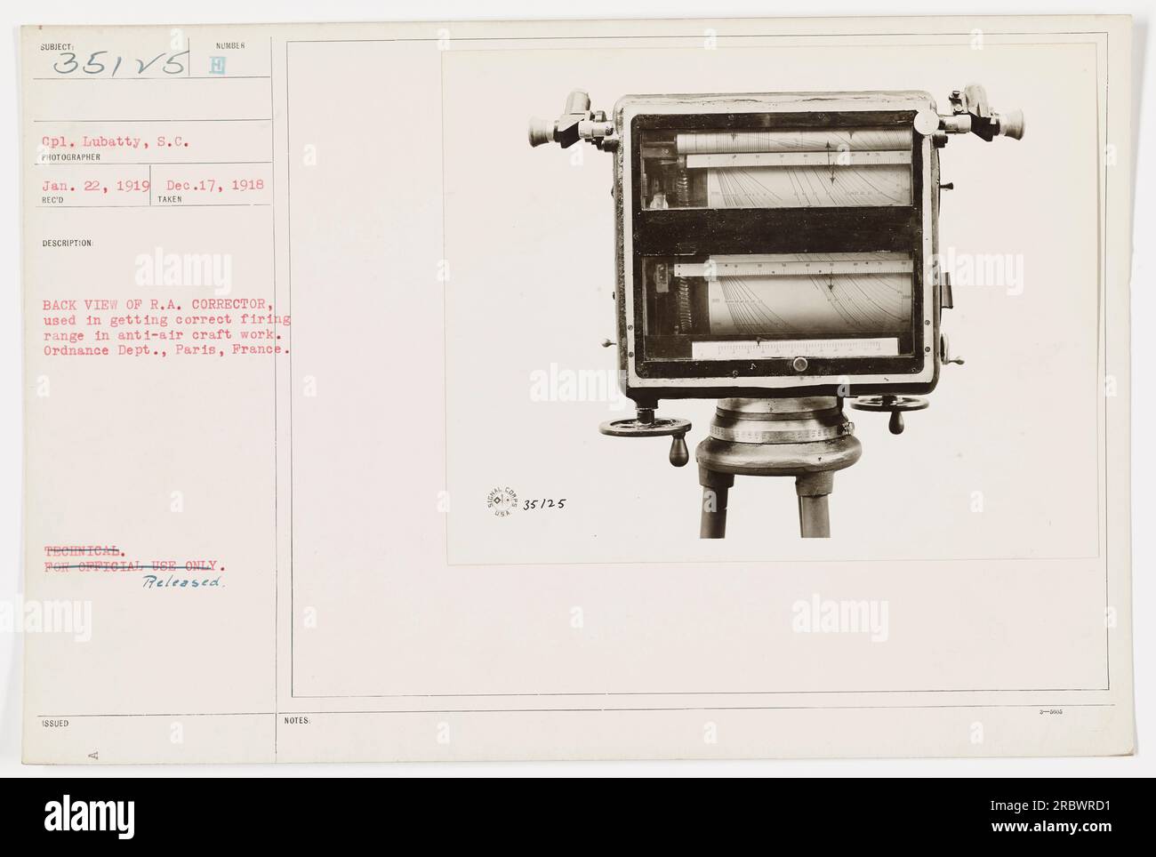 'Cpl. Lubatty using the R.A. Corrector, a device used to accurately calculate firing range during anti-aircraft operations. Photograph taken by a photographer from the Ordnance Dept. in Paris, France on Jan. 22, 1919. This image was numbered 35125 and was released for public distribution.' Stock Photo