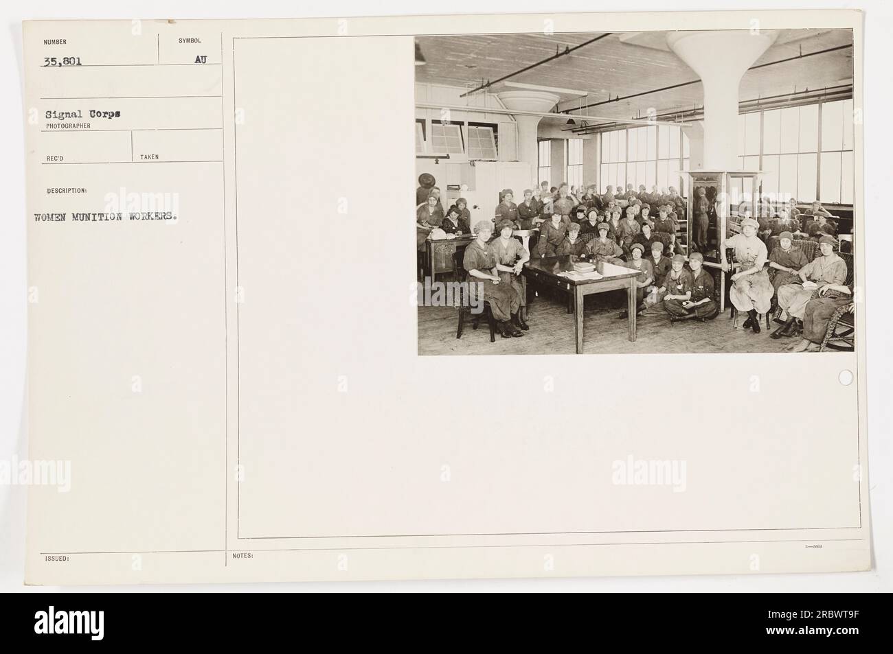 Women munition workers at work during World War I. They are seen carrying out various tasks, such as assembling ammunition and packaging it for distribution. The image showcases the significant role that women played in supporting the military effort during the war. Stock Photo