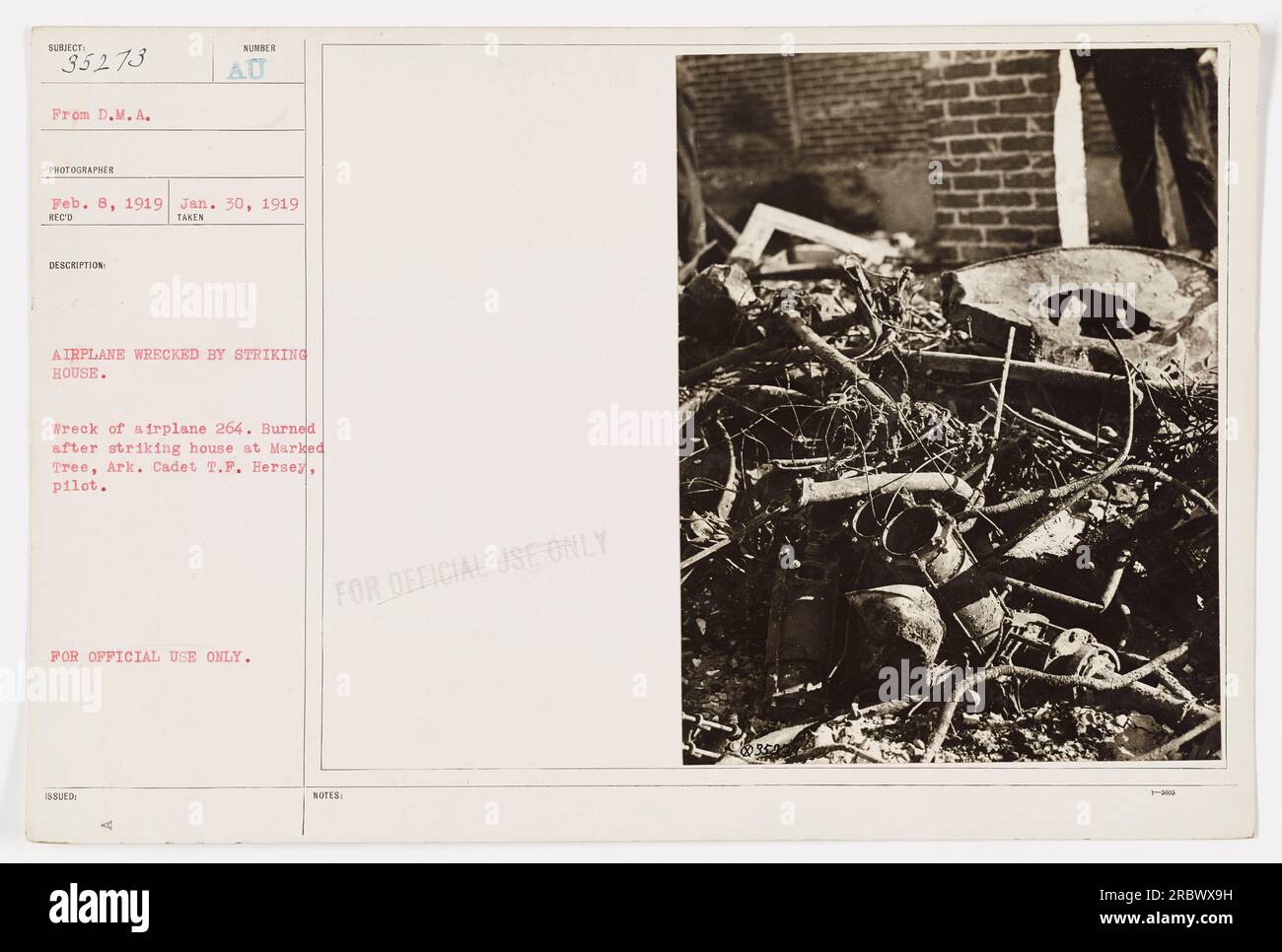 'Wreck of airplane 264 burned after striking a house in Marked Tree, Arkansas. The pilot, Cadet T.F. Hersey, was onboard during the incident. This photograph was taken on February 8, 1919, by a photographer from the D.M.A.' Stock Photo