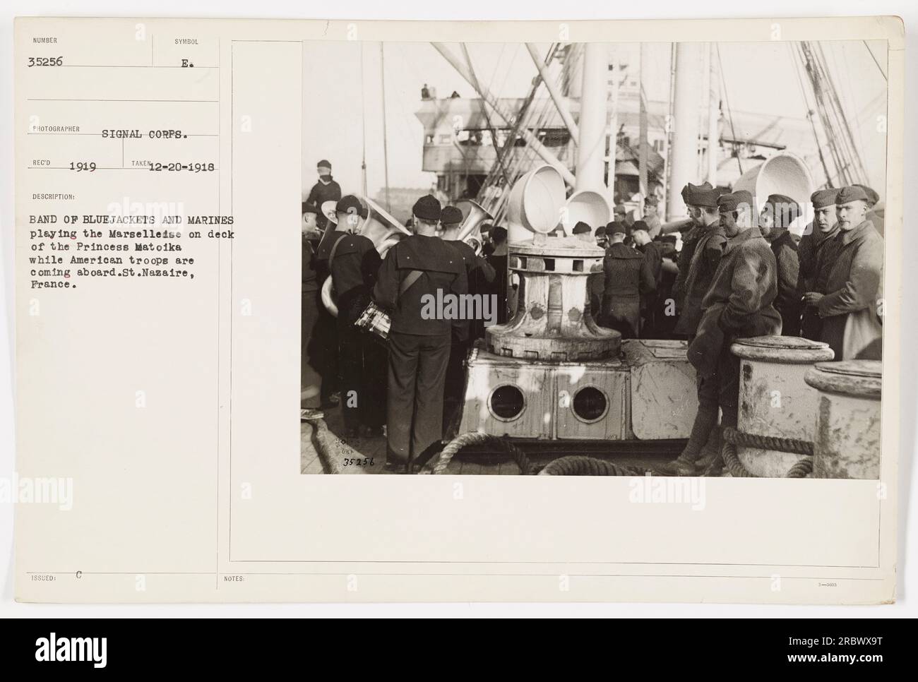 Bluejackets and Marines play the Marselleise on the deck of the Princess Matoika as American troops board the ship in St. Nazaire, France in December 1918. This photograph, numbered 35256, was taken by a Signal Corps photographer and is part of a collection known as Veld 1919. Stock Photo